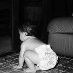 Baby crawling in a Rebelalike diaper with Messy But It's OK print, black and white