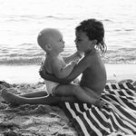Baby and big brother on the beach in Ibiza, black and white