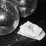 Rebelalike printed diapers next to disco balls, black and white