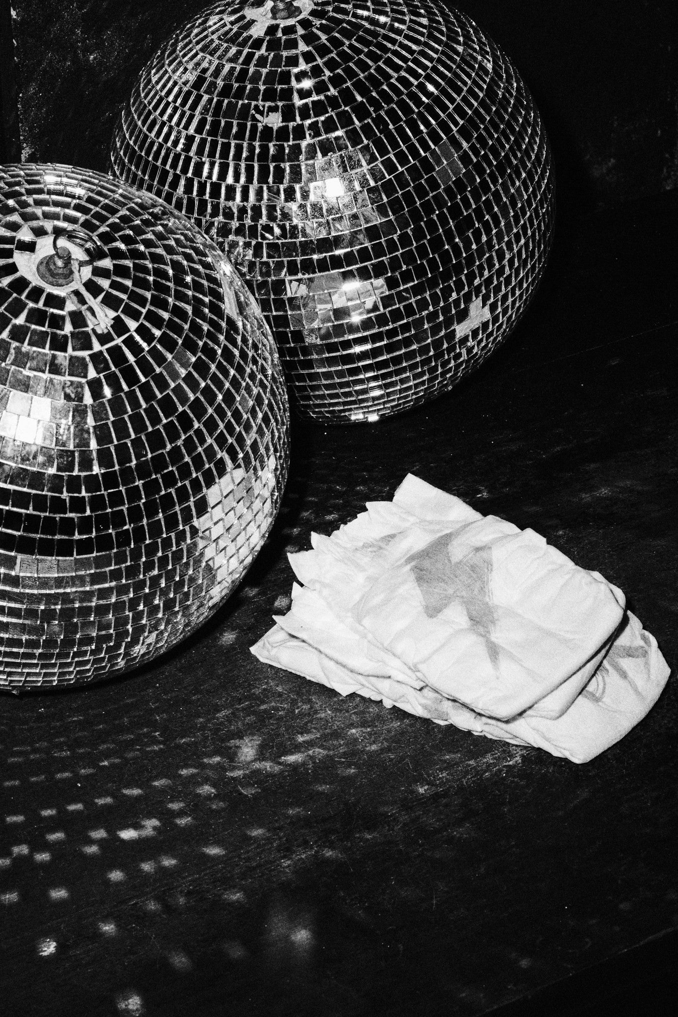 Rebelalike printed diapers next to disco balls, black and white