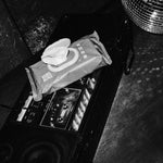 Rebelalike baby wipes on a boombox next to a disco ball, black and white