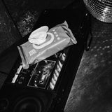 Rebelalike baby wipes on a boombox next to a disco ball, black and white